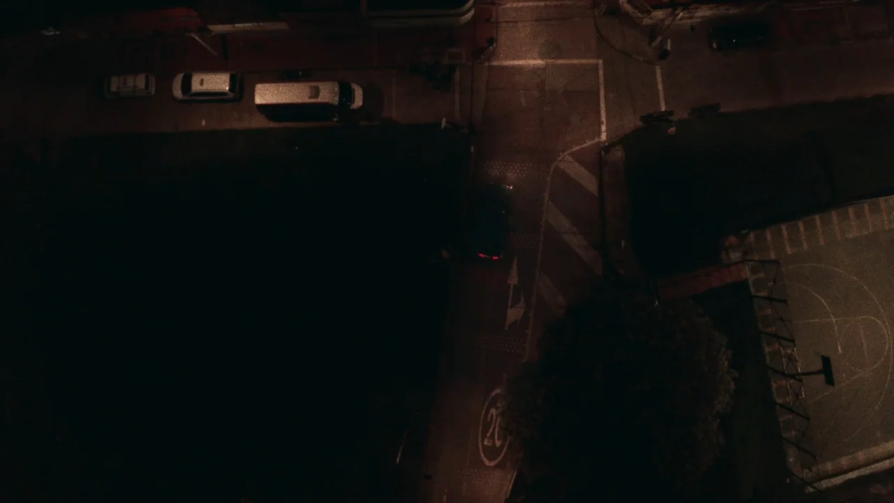 An Affair: A Dangerous Sexual Play (2014) movie still: establishing — An asphalt road intersection is seen from a high, top-down perspective at…