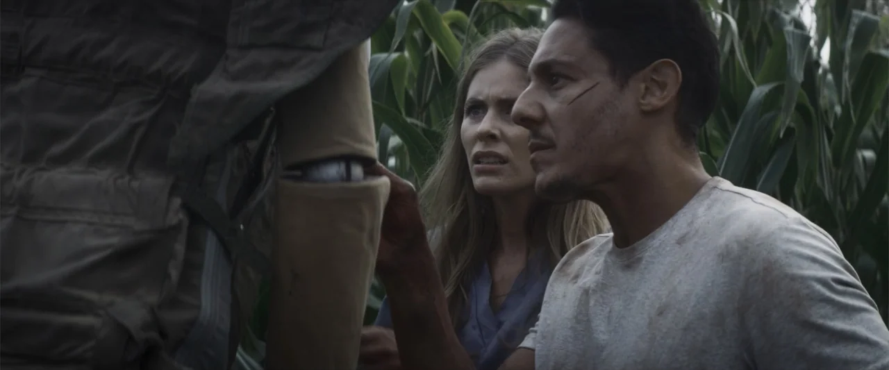 Treblinka's Last Witness (2012) movie still: medium — Tall green corn stalks surround the two figures in an open field setting. A man and a woman…