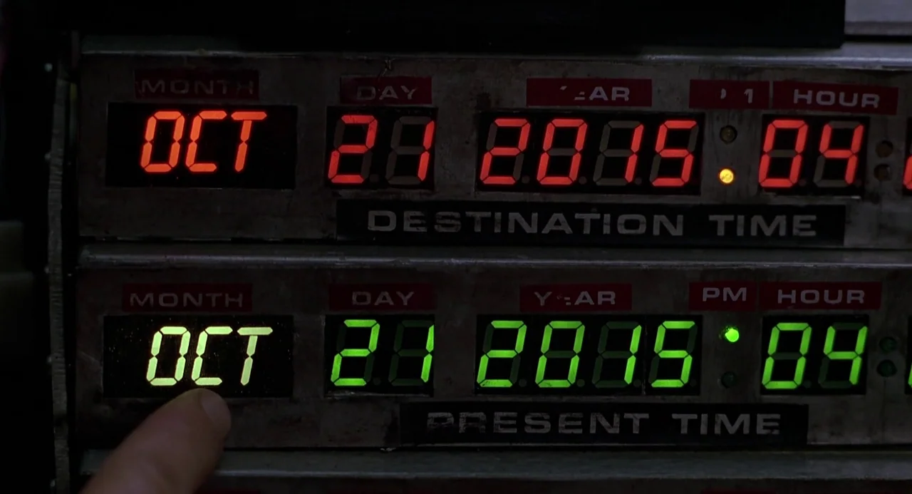 Back to the Future II (1989) movie still: closeup — A metal time display panel features glowing red destination numbers and green present time…