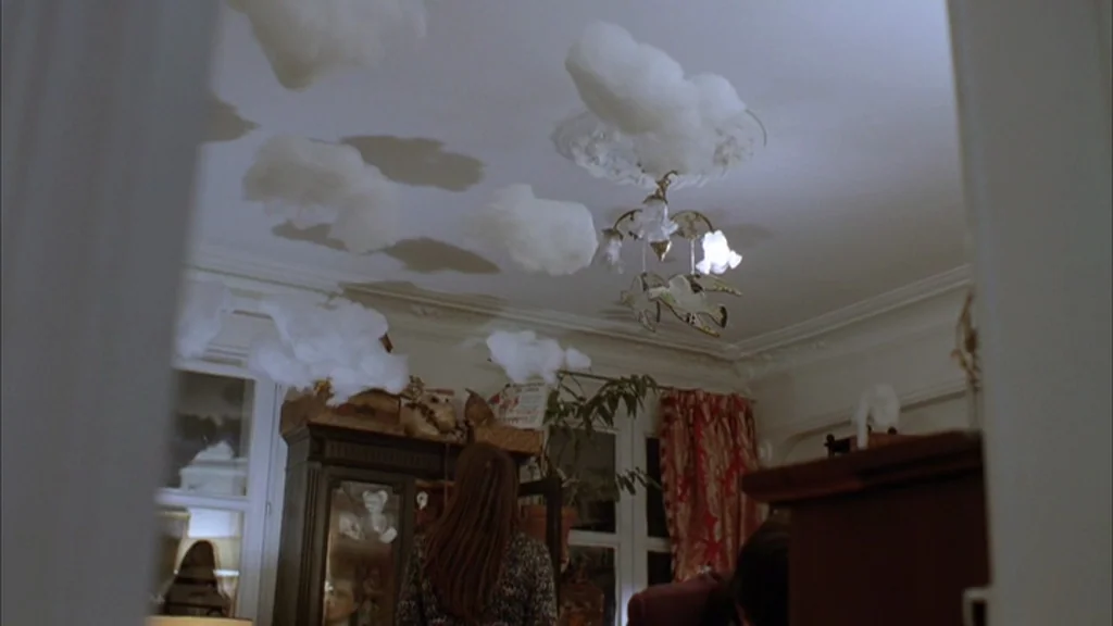 The Science Of Sleep (2006) movie still: medium — A room interior features a white ceiling decorated with artificial cotton clouds. A woman stands…
