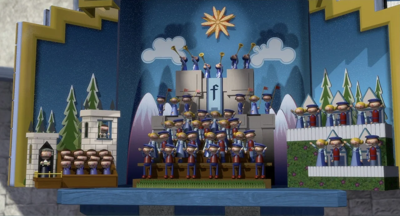 Shrek (2001) movie still: wide — A miniature wooden cuckoo clock display features a crowd of figures on tiered platforms. Multiple stylized dolls…