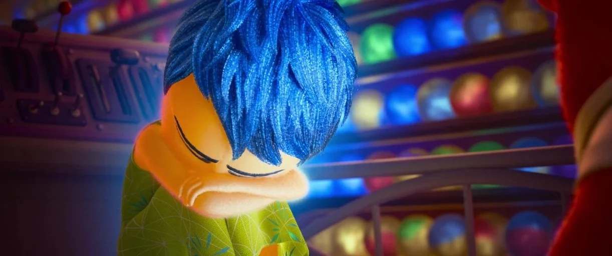Inside Out 2 (2024) movie still: closeup — A high-tech control room contains shelves filled with numerous colorful, glowing spherical memories. A…