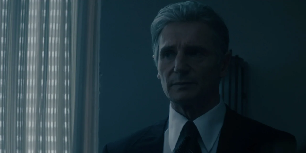 Mark Felt: The Man Who Brought Down the White House (2017) movie still: closeup — A dimly lit room features a window with vertical blinds on the…