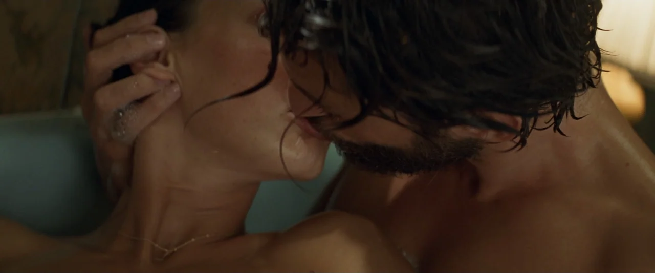 Masquerade (2022) movie still: closeup — A close-up view shows a couple in a filled bathtub. They are face to face while embracing in the water.