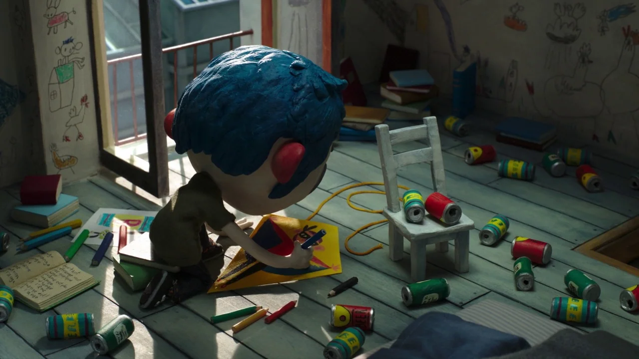 My Life as a Zucchini (2016) movie still: medium — A cluttered room features light-colored wooden floorboards covered in children's drawings and…