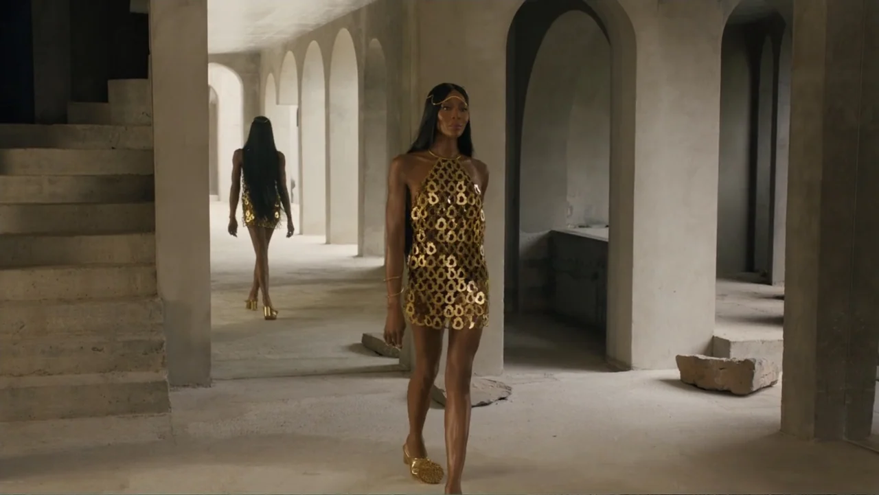 Victoria's Secret: The Tour '23 (2023) movie still: fullbody — A minimalist interior space features a long row of concrete arches and bare floors. A…