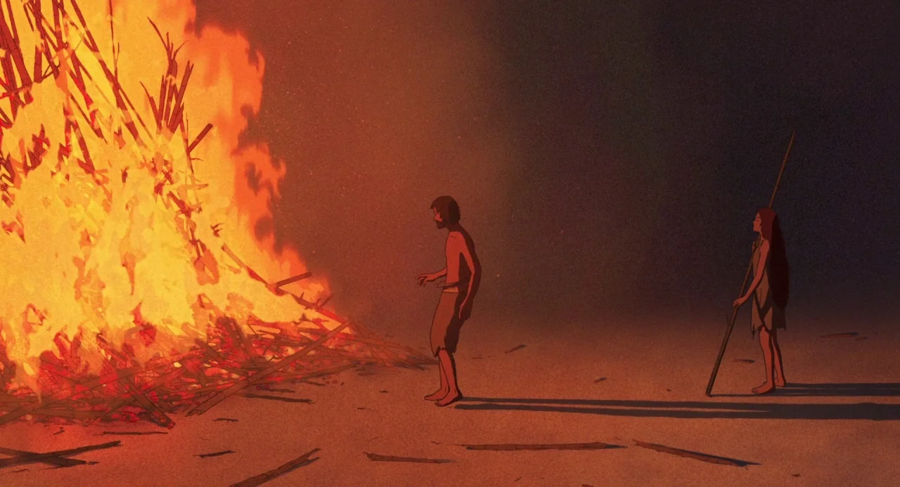 The Red Turtle (2016) movie still: wide — A desolate, dark landscape is illuminated primarily by a large, crackling campfire. A man and a woman…