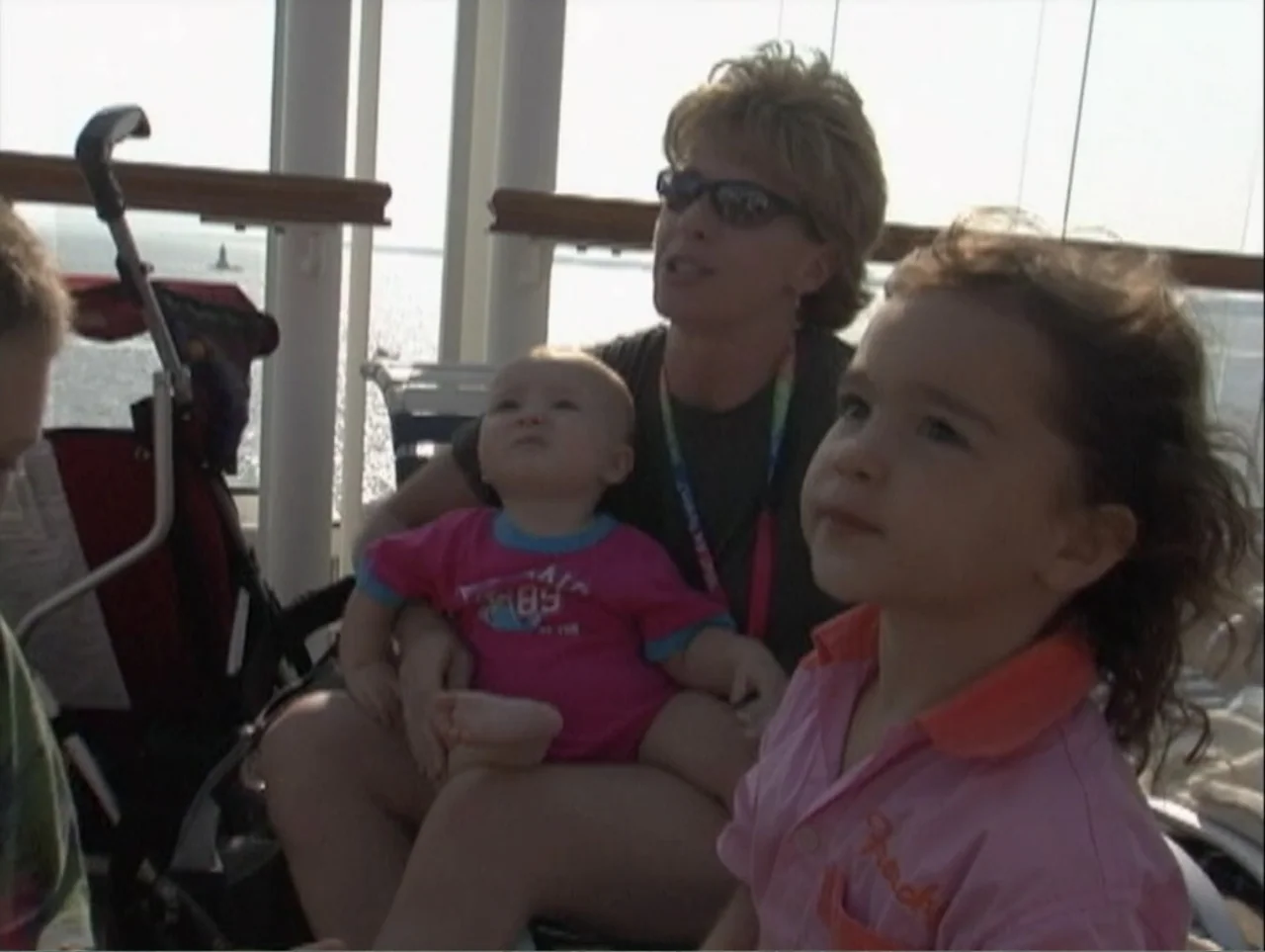 All Aboard! Rosie's Family Cruise (2006) movie still: medium — A woman sits on a cruise ship deck with a toddler and an infant. The group looks out…
