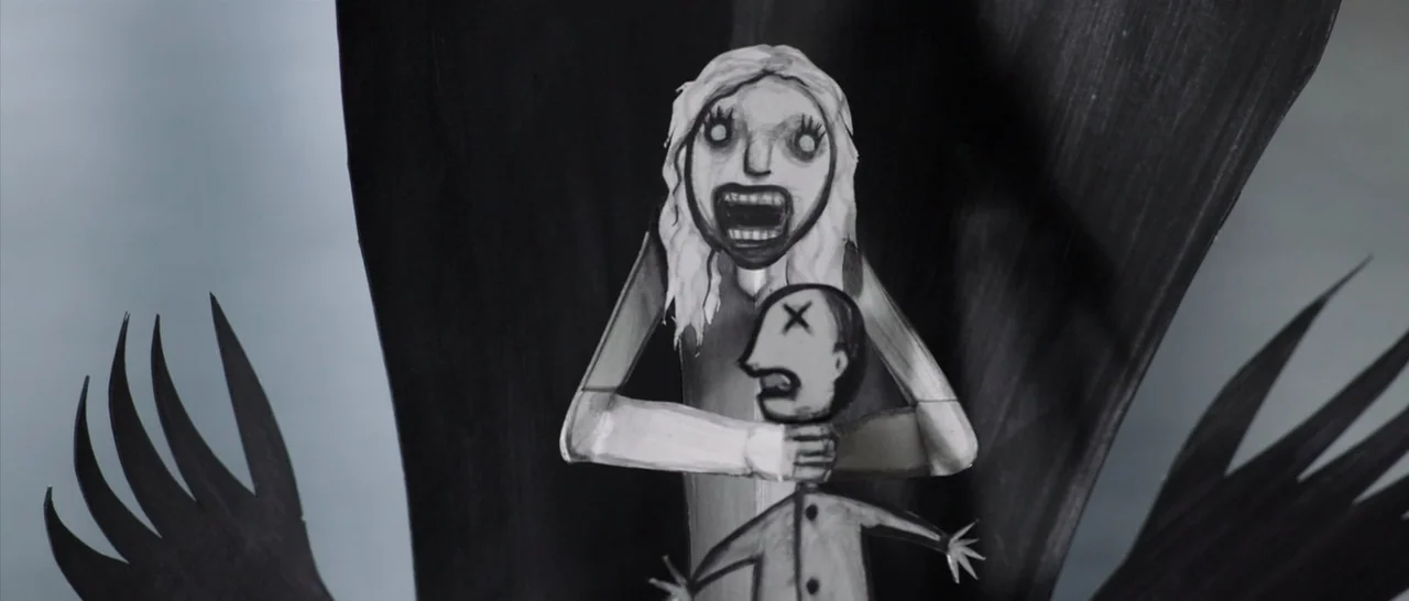 The Babadook (2014) movie still: medium — Two-dimensional hand-drawn paper puppets are positioned against a textured black background. A female…