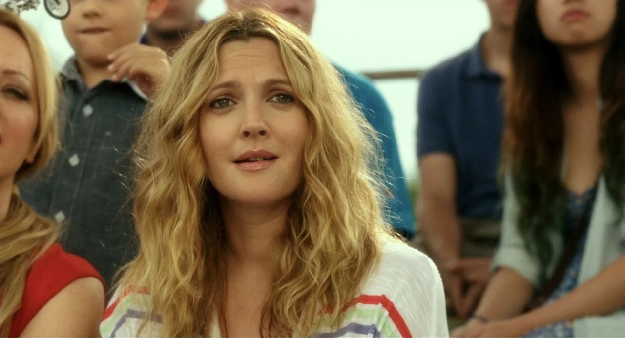 Blended (2014) movie still: medium — An outdoor seating area is filled with several people in a crowd. A woman in the foreground looks forward with…