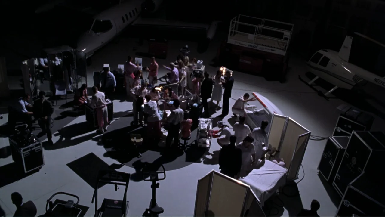 Miss Congeniality (2000) movie still: wide — An aircraft hangar is converted into a makeshift clinical station with portable medical partitions.…