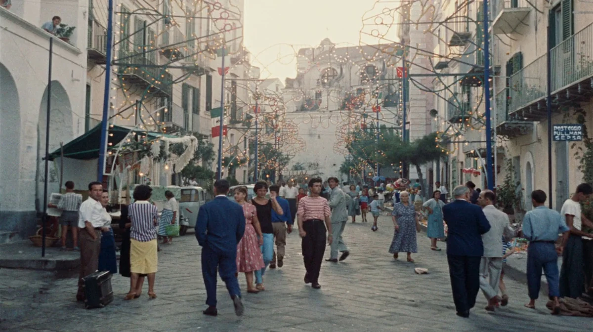 Purple Noon (Plein Soleil) (1960) movie still: wide — A stone-paved thoroughfare lined with traditional buildings and decorative arches of fairy…