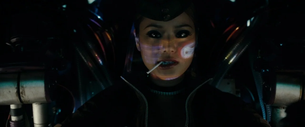 Sucker Punch (2011) movie still: closeup — A dark, cramped mechanical environment filled with metal tubes and complex pilot machinery. A young woman…
