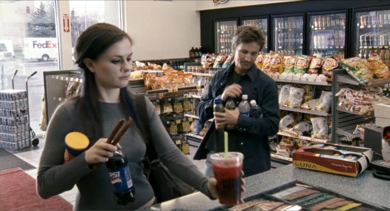 Colin Quinn: Red State, Blue State (2019) movie still: medium — A brightly lit convenience store interior features rows of snack shelves and…