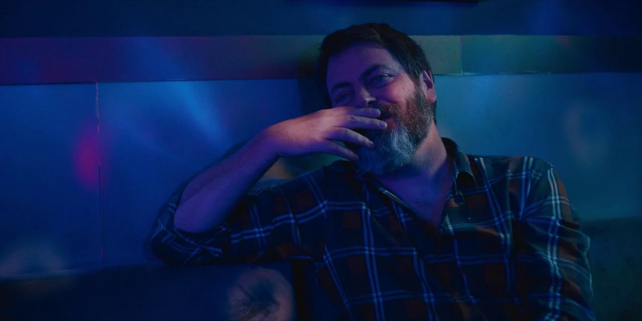 Hearts Beat Loud (2018) movie still: medium — A dark bar booth features metallic backlighting illuminated by blue and magenta neon lights. A bearded…