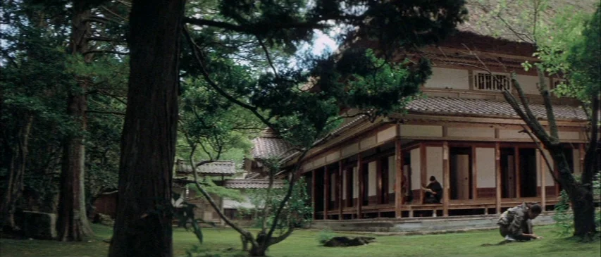 The Horrors of Malformed Men (1969) movie still: wide — A traditional Japanese wooden building stands in a lush garden filled with large trees. One…