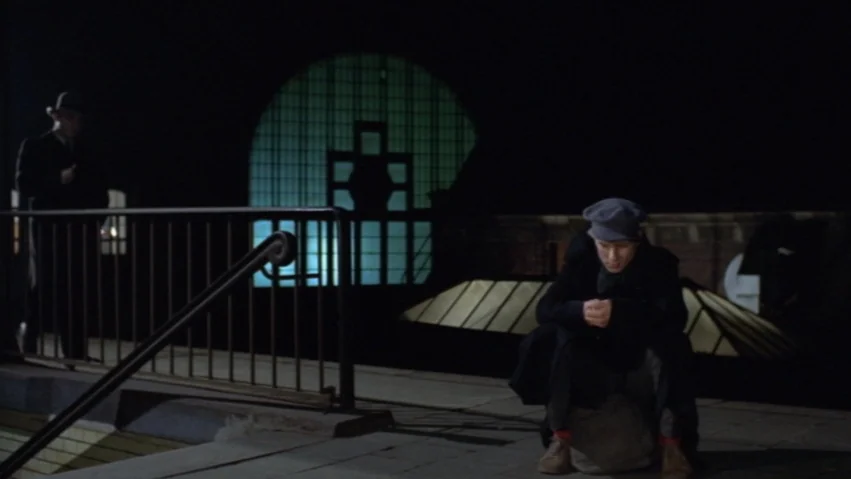 Tenderness of the Wolves (1973) movie still: wide — An empty nighttime train platform features a large, glowing, arched window in the background. A…