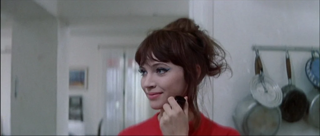 Une Femme Est Une Femme (A Woman Is a Woman) (1961) movie still: closeup — A bright domestic space featuring white walls and hanging metal cookware…