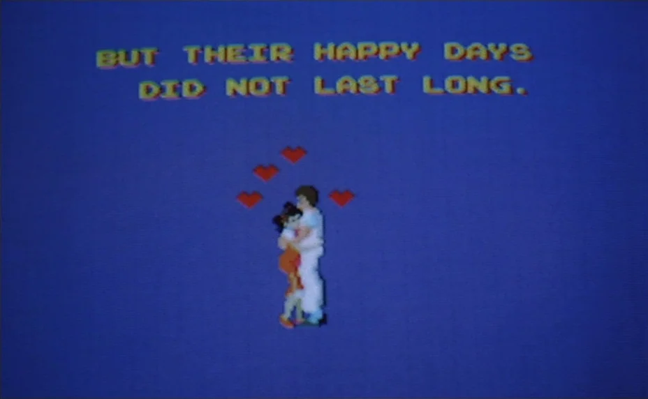 Kung Fu Master! (1988) movie still: wide — A low-resolution digital graphic displays text against a solid blue background. A pixelated couple…