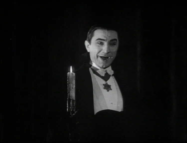 Dracula (1931) movie still: medium — A dark space with no visible architectural features surrounding the figure. A man in formal evening wear stands…