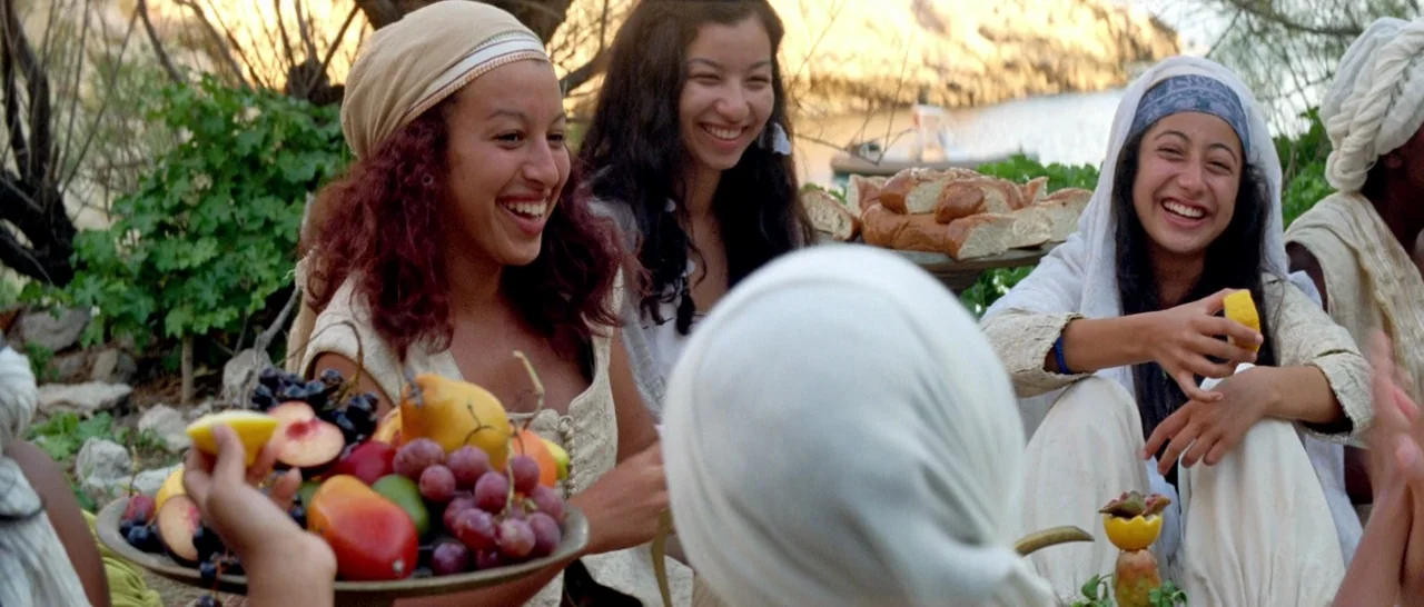 Arabian Nights: Volume 1 – The Restless One (2015) movie still: medium — A group of women in light-colored historical garments sit together outdoors…