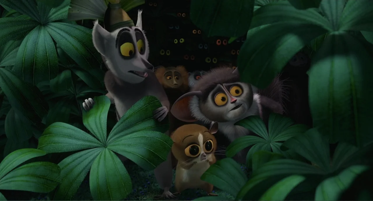 Madagascar (2005) movie still: medium — A dense dark jungle environment with large tropical leaves framing a small group. Three lemurs peer out from…