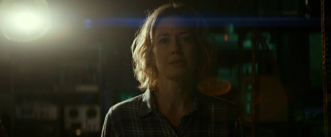 Ghostbusters: Afterlife (2021) movie still: medium — A dark, dimly lit storage space contains shelves filled with obscured equipment and boxes. A…