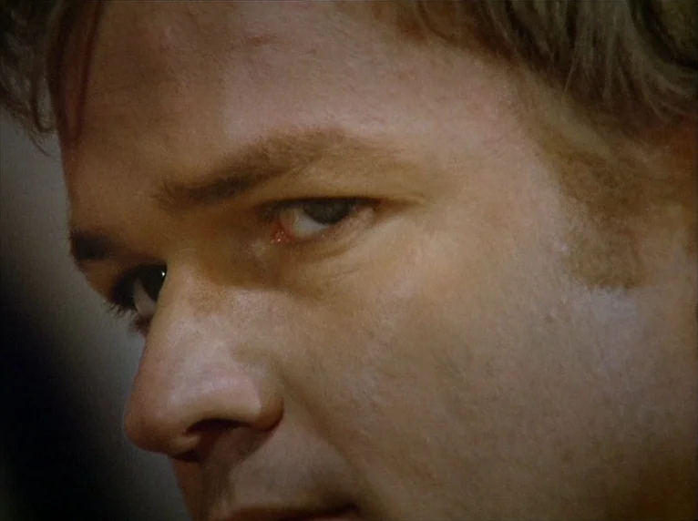 Beware Of A Holy Whore (1971) movie still: closeup — A close view of a man's face fills the frame. The subject looks off-camera while partially lit…
