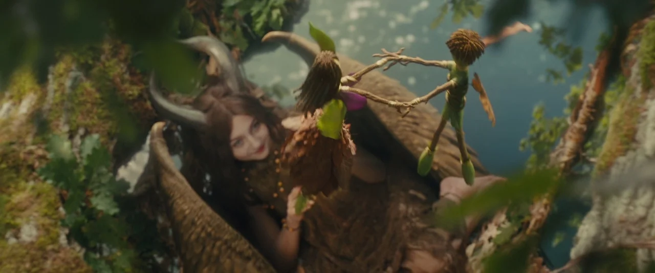 Maleficent (2014) movie still: wide — A woman with horns rests in a natural forest setting near a small stream. She holds two small twig figures and…