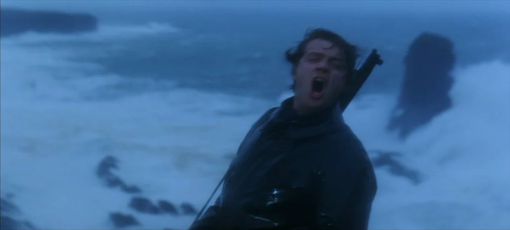 Ryan’s Daughter (1970) movie still: medium — A storm-swept coastal cliff overlooking a turbulent, white-capped ocean under overcast skies. A young…