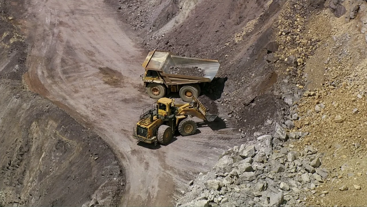The Alps from Above: Symphony of Summits (2014) movie still: wide — An open-pit mine features steep gravel embankments and a wide dirt access road.…