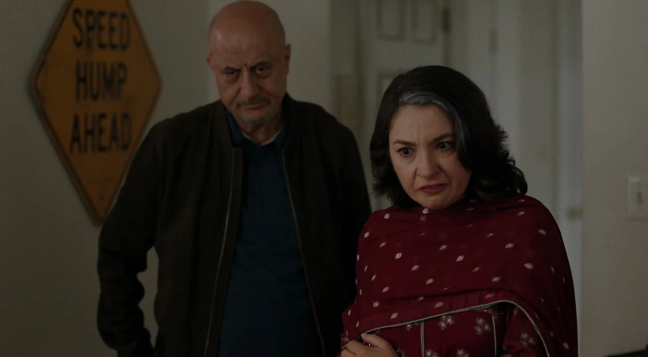 The Big Sick (2017) movie still: medium — A residential hallway features a yellow traffic sign hanging on the off-white wall. A man and a woman…