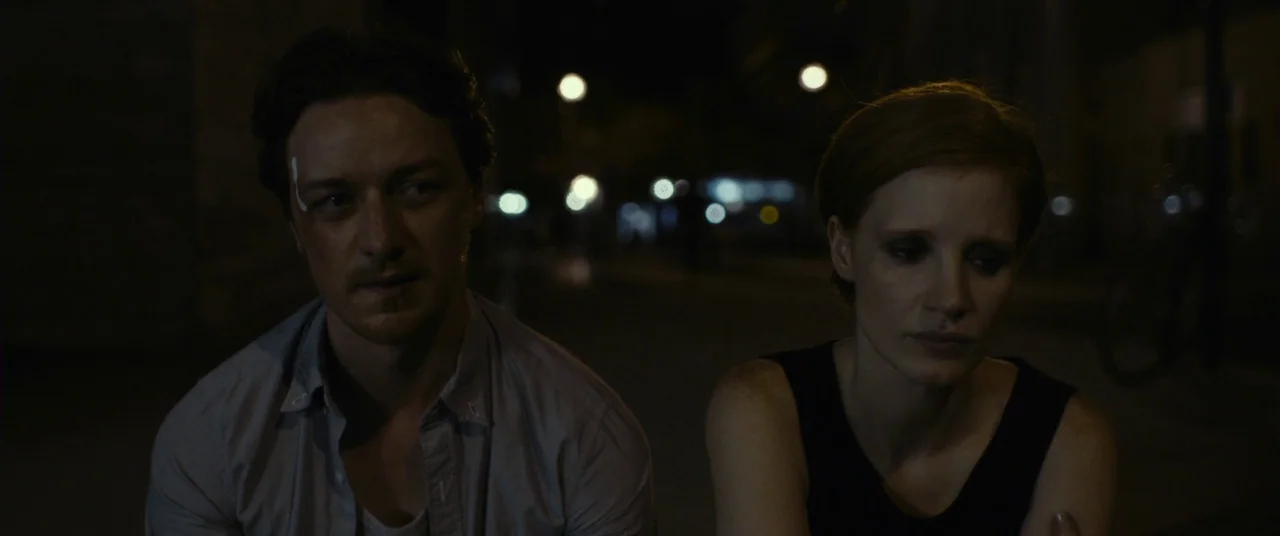 The Disappearance of Eleanor Rigby: Him (2014) movie still: medium — A dark city street at night with distant out-of-focus streetlights. A man and a…