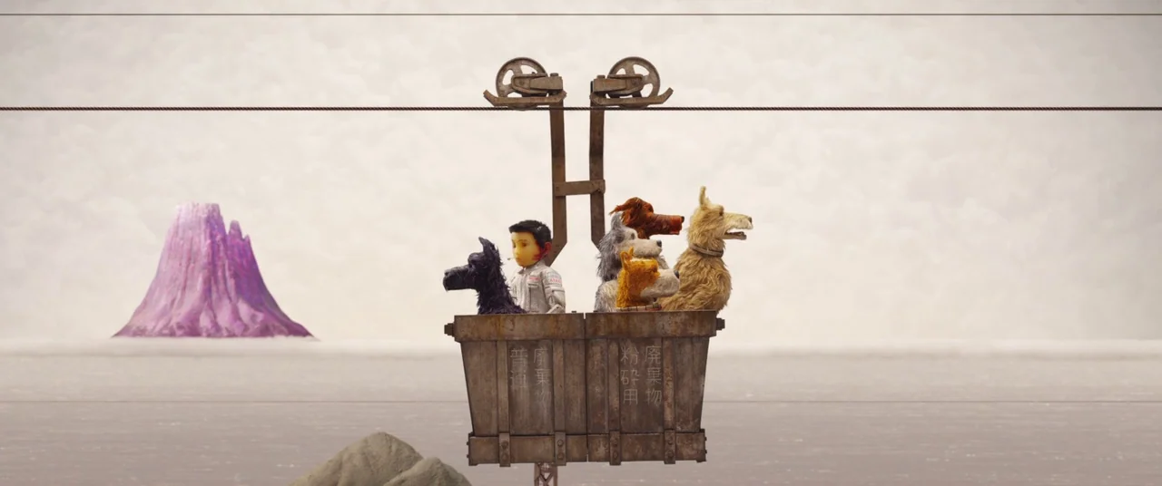 Isle of Dogs (2018) movie still: wide — A weathered metal mining bucket carries passengers across an expanse of grey fog. A lone purple-colored…