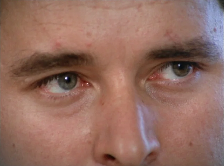 The Merchant Of The Four Seasons (1971) movie still: closeup — A close-up view shows the eyes and nose bridge of a young male face. The skin texture…