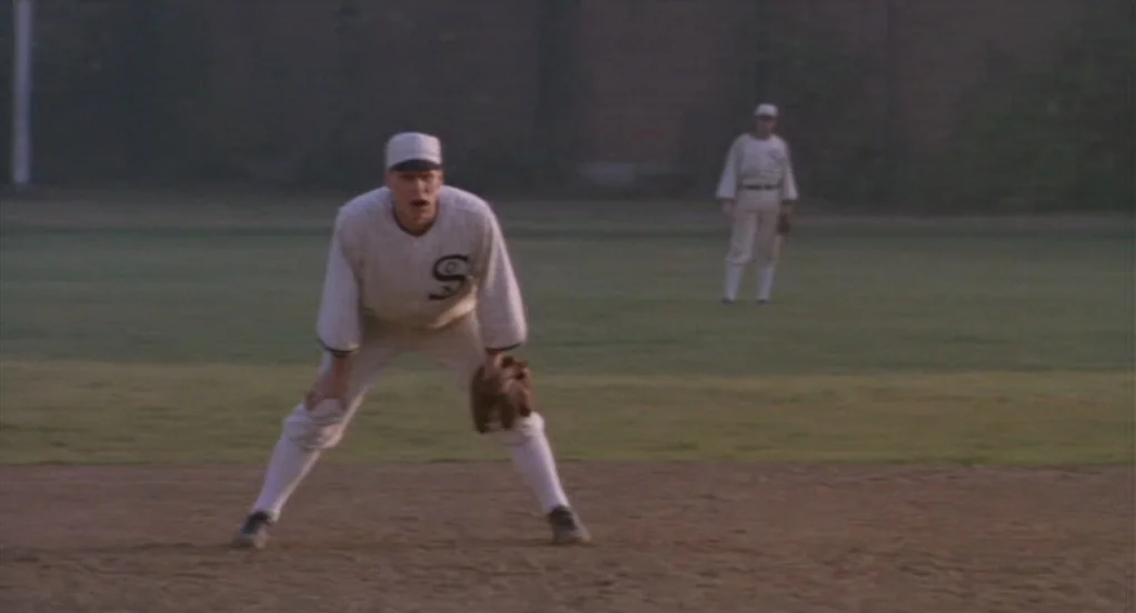 Eight Men Out (1988) movie still: fullbody — A baseball player stands on a dirt infield wearing a period-appropriate uniform. Another player stands…