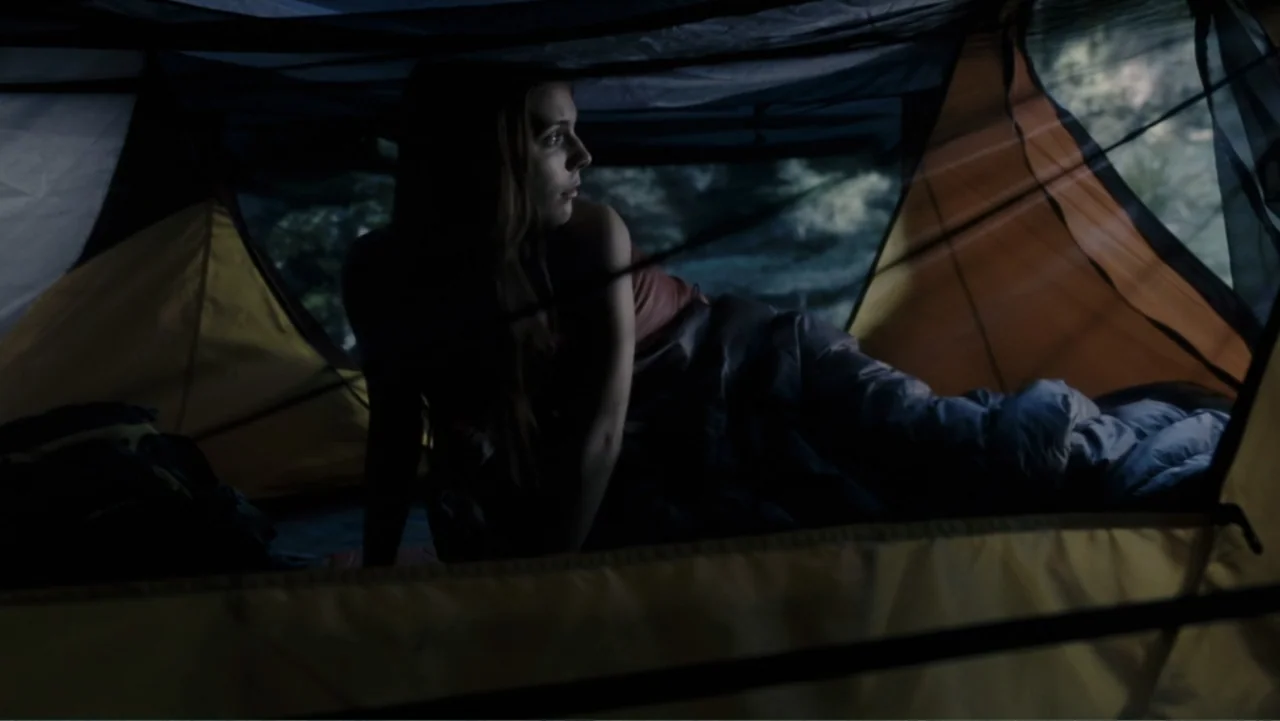 Tomorrow, When the War Began (2010) movie still: medium — The interior of a yellow nylon camping tent during low light conditions outdoors. A young…
