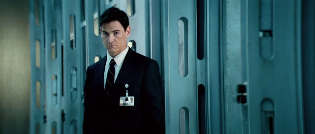 Mission: Impossible III (2006) movie still: medium — A clinical-looking industrial hallway features rows of tall metal storage lockers or…