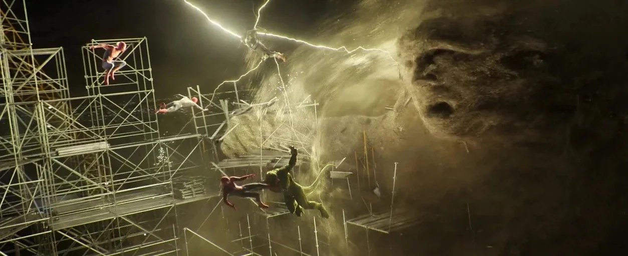Spider-Man: No Way Home (2021) movie still: wide — A complex metal scaffolding structure stands amidst a swirling dark dust cloud at night. Three…