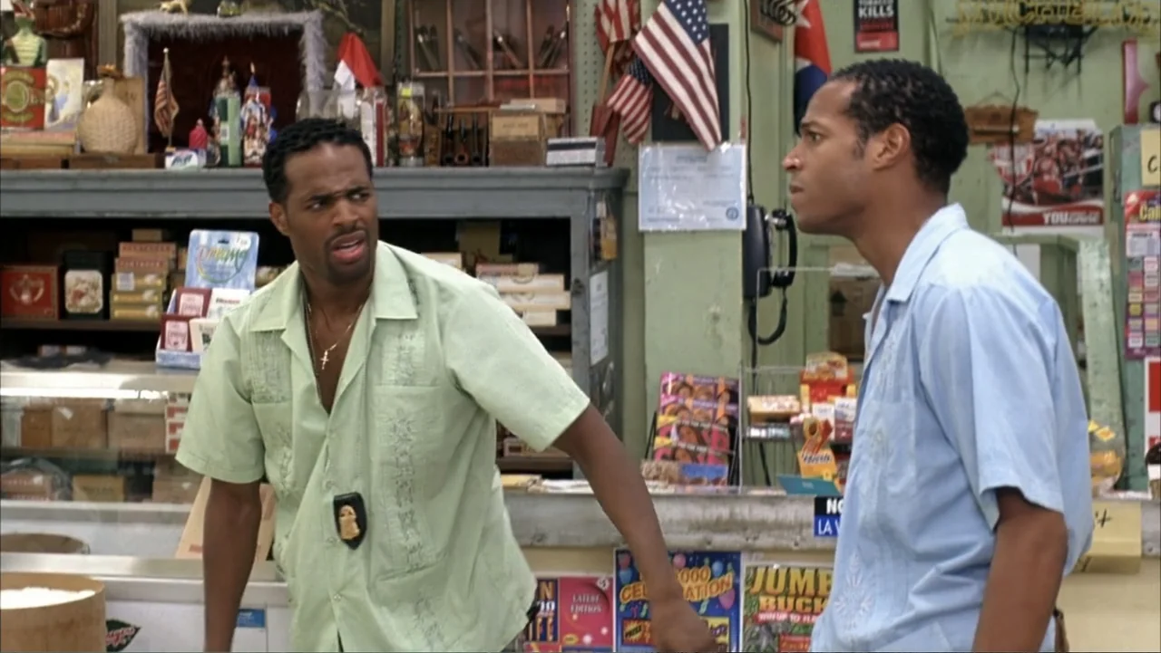 White Chicks (2004) movie still: medium — A cluttered convenience store counter with shelves of various merchandise and American flags visible. Two…