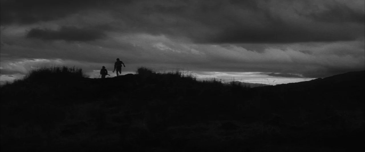 The Human Condition III: A Soldier’s Prayer (1961) movie still: wide — A dark, uneven grassy ridge sits under a heavily clouded, expansive night…