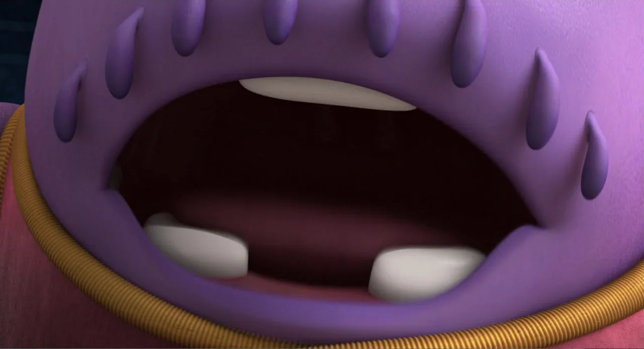 Home (2015) movie still: closeup — A close-up view focuses on the lower face of a stylized purple character. The mouth is open to reveal dark…