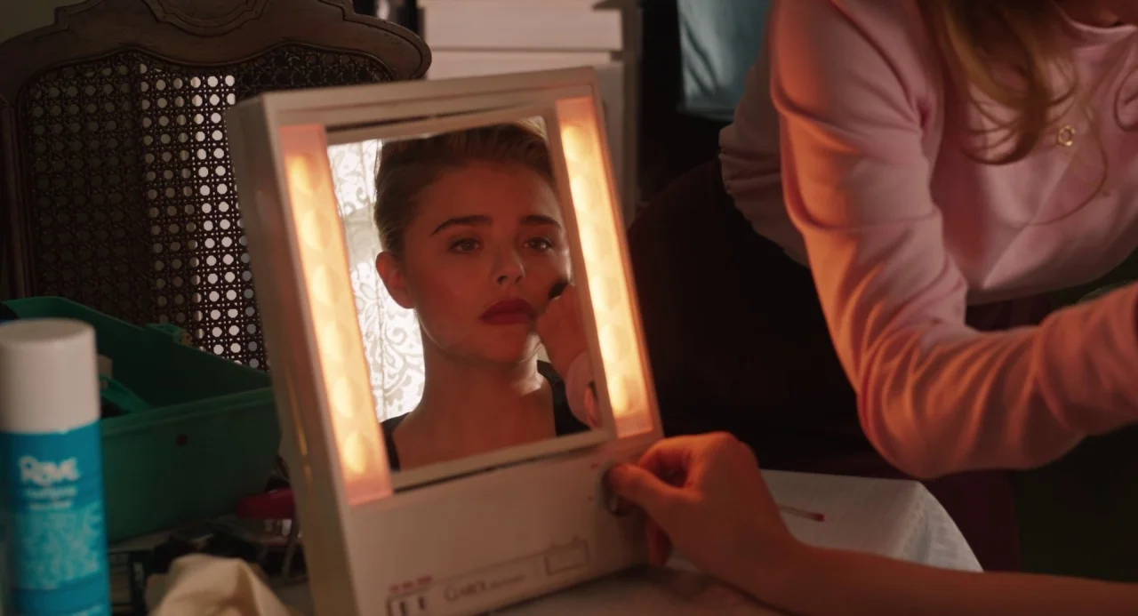 The Miseducation of Cameron Post (2018) movie still: medium — A cluttered vanity table holds a lit makeup mirror, aerosol can, and green bin in a…