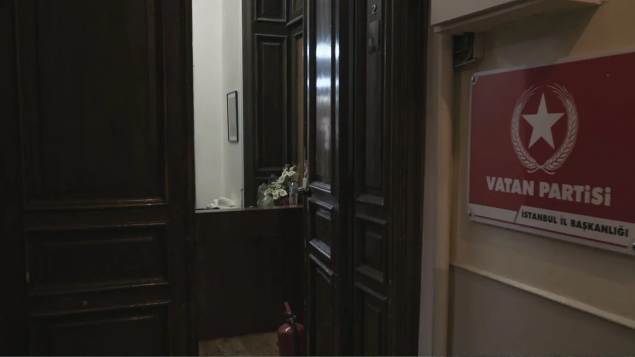 A Gift from God (2019) movie still: medium — An open doorway leads into a dim interior room featuring dark wood paneling. A white and red political…