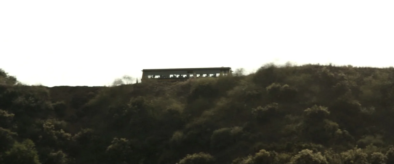 True Account: Breaking the Truce (Yakuza Bloody Chronicles 2) (2007) movie still: wide — A passenger train is positioned atop a steep hillside…