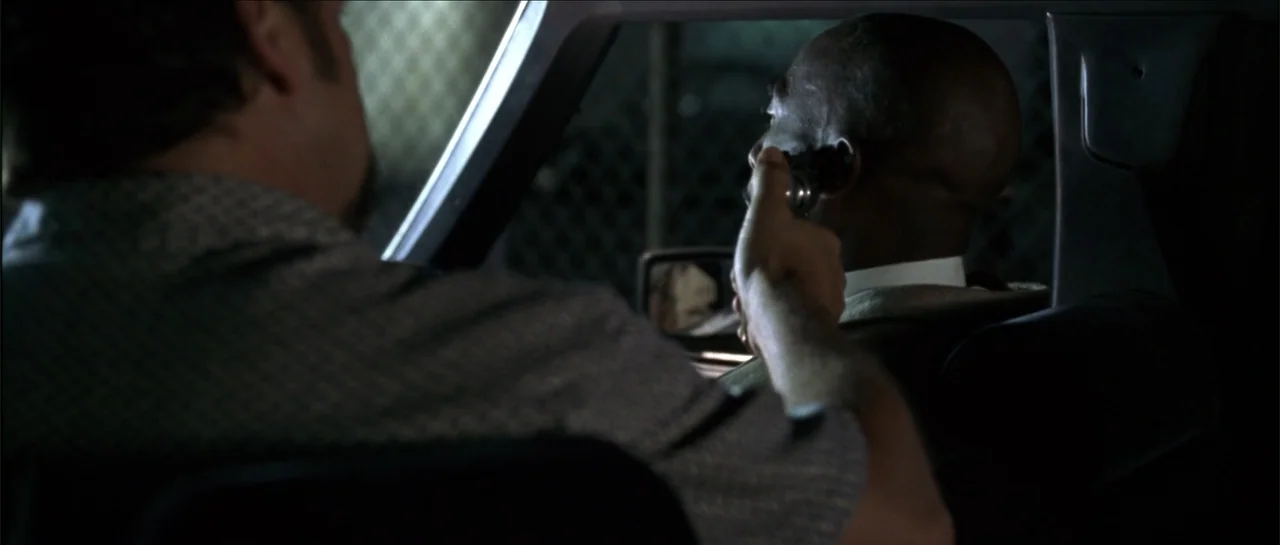 Gang Related (1997) movie still: medium — A dark car interior at night shows a close proximity between two individuals. A person in the backseat…