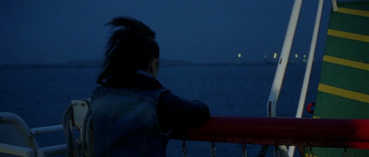 Arabian Nights: Volume 1 – The Restless One (2015) movie still: medium — A person stands on the deck of a boat at night over dark water. They lean…