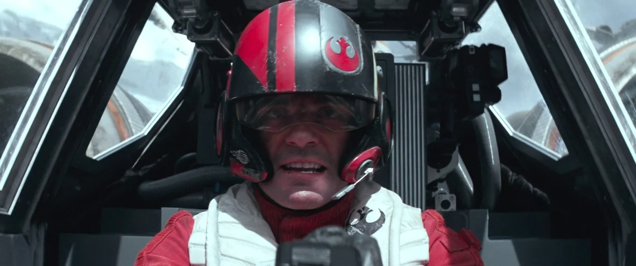 Star Wars: The Force Awakens (2015) movie still: closeup — The pilot sits inside a cramped, technological cockpit with visible flight…