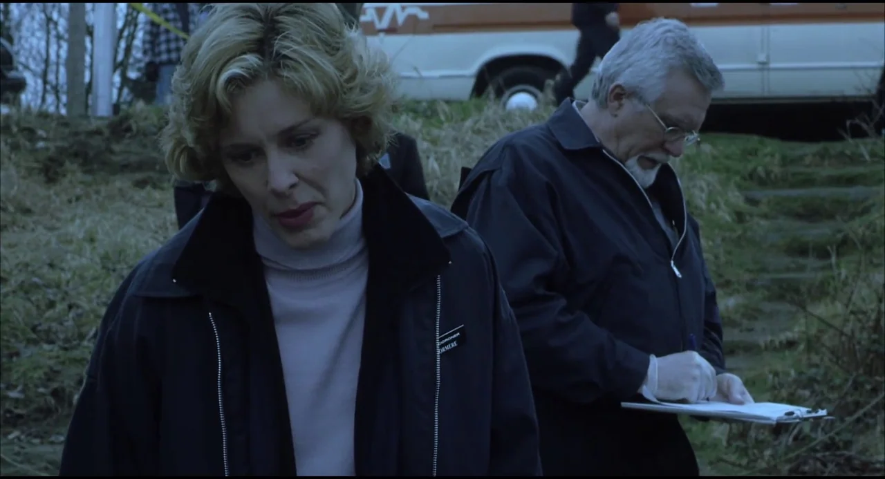 Hellraiser: Hellseeker (2002) movie still: medium — An outdoor area with dry grass and a parked white van in the background. A blonde woman and an…