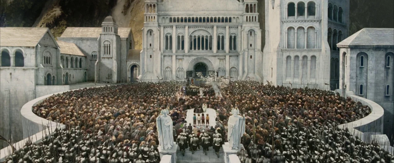 The Lord of The Rings: The Return of the King (2003) movie still: establishing — A vast, white stone courtyard is surrounded by tall, elaborate…